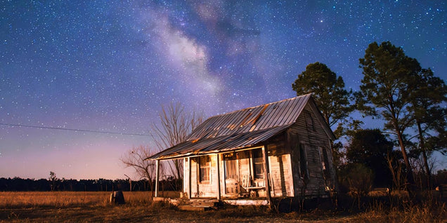 Off-grid cabin in Alabama wet woods, morning fog settling around timber walls, powered by LiTime 48V 3500W solar system.