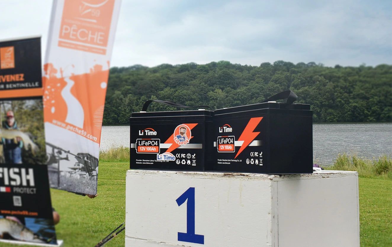 Two LiTime 100Ah batteries sit on the first-place block of a winners' podium at the Peche Fishing Game event