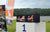 Two LiTime 100Ah batteries sit on the first-place block of a winners' podium at the Peche Fishing Game event