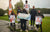 The winners of a LiTime-sponsored fishing competition pose on a podium with their prize check and branded t-shirts