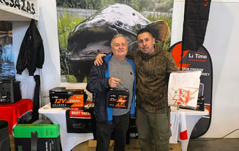 the attendee holding a litime prize battery and t-shirt at the Hungarian Fishing Expo