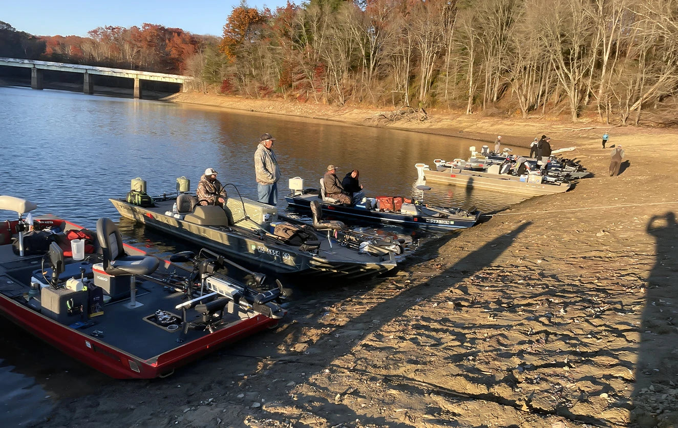 Anglers and their electric bass boats gathered on a reservoir shore for the Electric Bass Anglers event