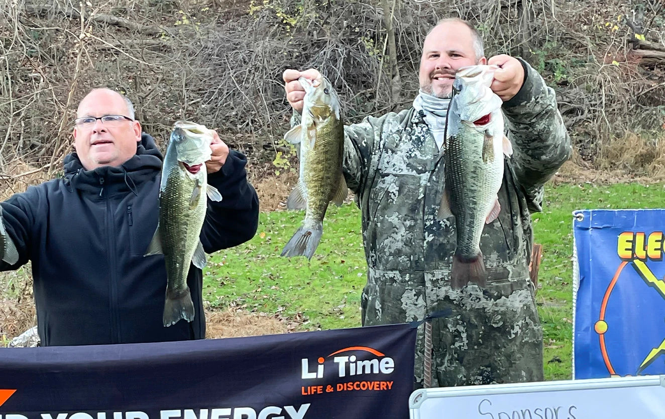Two smiling fishermen display their bass at the weigh-in for the LiTime-sponsored Electric Bass Anglers event