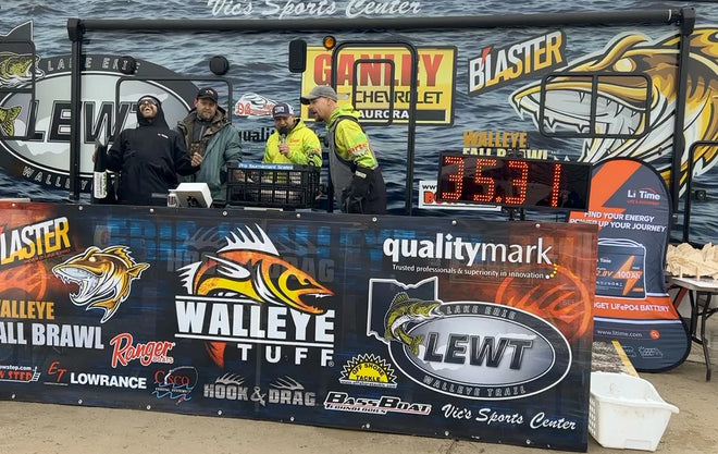 Anglers celebrate a 35.31 lb weigh-in on the LEWT stage, with a Li Time sponsor banner