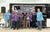 The "Hawks Fishing" team and their coaches pose with a large trophy at an Alabama Student Angler Bass Fishing event