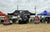 The "Hawks Fishing" team tent, sponsored by Li Time, is set up alongside other teams at an outdoor tournament