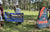 An angler proudly holds up his bass between the Electric Bass Anglers and Li Time sponsor banners.