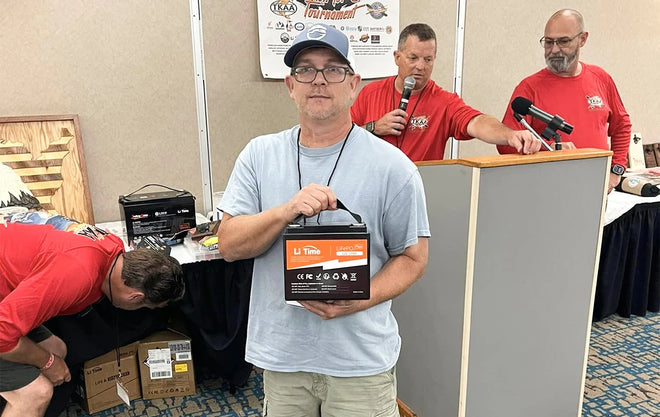 a man holds a LiTime battery at a "heroes on the water" event