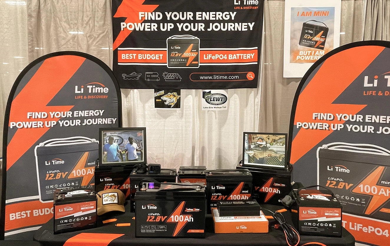 The fully stocked Li Time vendor booth at a Fishing & Hunting Show, displaying a wide array of LiFePO4 batteries