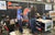 A father and son learn about Li Time batteries from a representative at the Fishing and Hunting Show