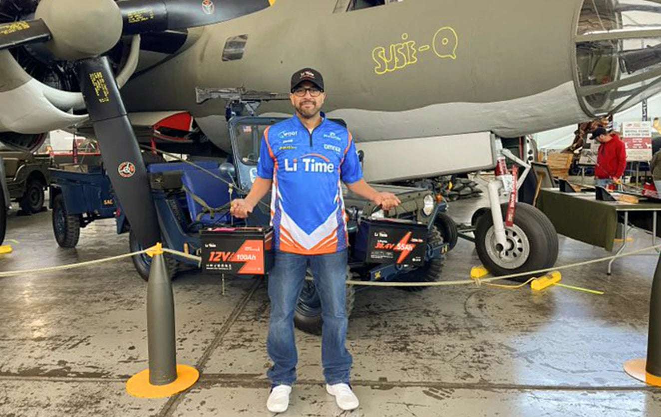 A Li Time rep poses with batteries in a unique, military-themed booth at a Fishing and Hunting Show