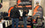 A Li Time representative talks with a customer in their branded booth at an indoor Fishing and Hunting Show