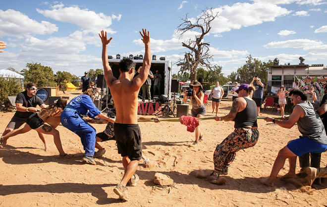 Attendees compete in the tug-of-war game in a sandy lot during the Moonlanding RV event