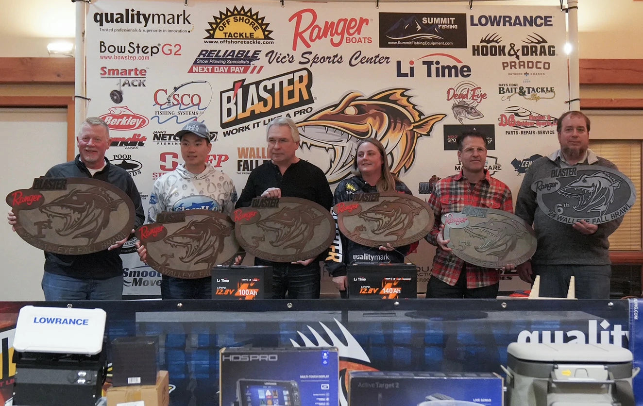 The winners of the Walleye Fall Brawl tournament pose with large, fish-shaped trophies in front of a sponsor wall featuring LiTime
