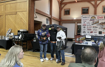 A winning team of three fishermen on stage at the Walleye Fall Brawl, holding  LiTime batteries