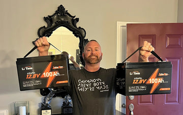 a man of MLF winner holding two of LitIME 12V 100Ah trolling motor batteries