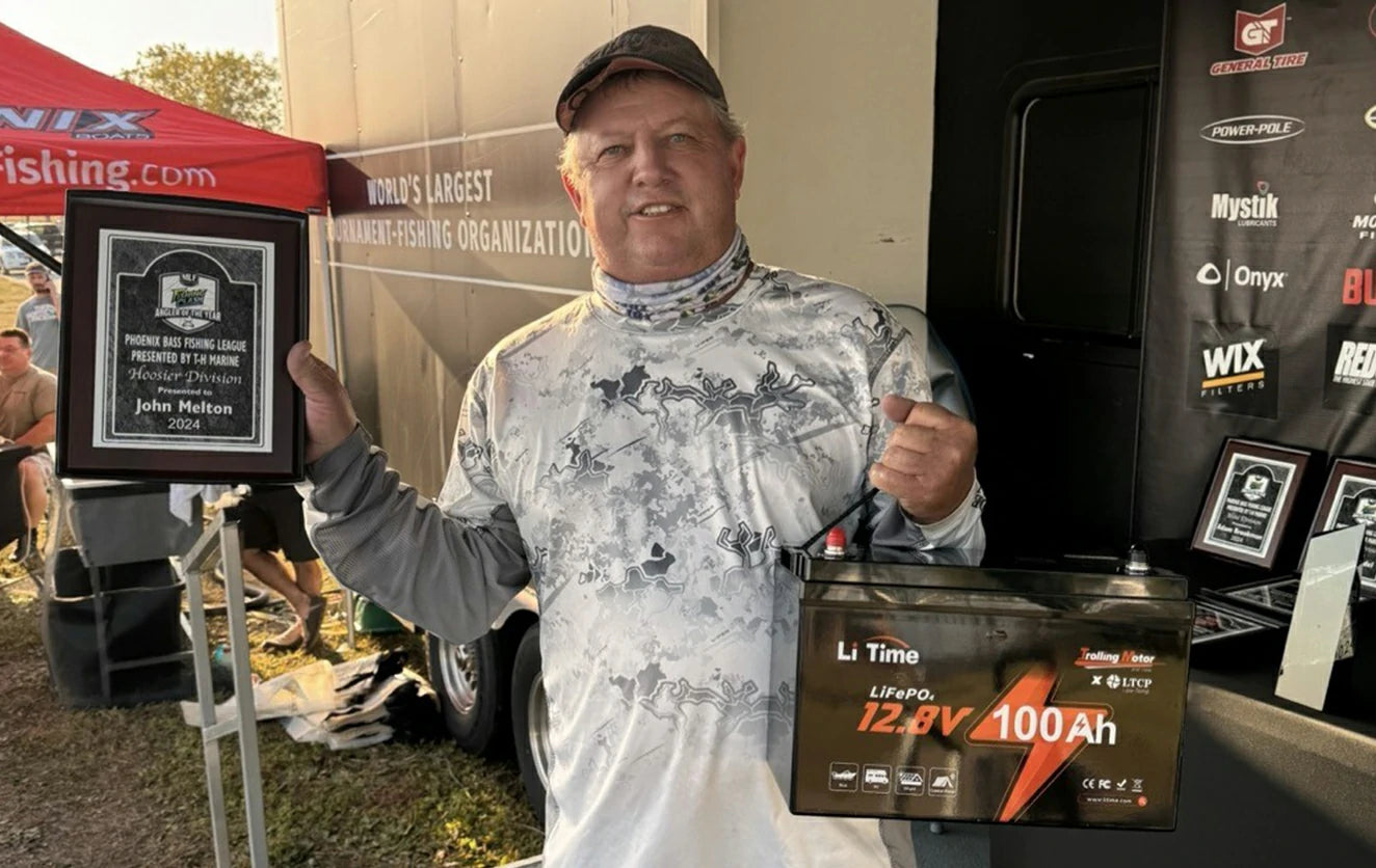 customer proudly holding an award and a LiTime 12V 100Ah trolling motor battery, highlighting positive LiTime customer review