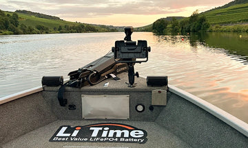 View over the bow of a fishing boat with a LiTime floor mat, looking down a river at sunset