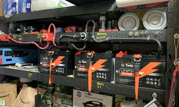 shelf filled with LiTime 12V 100Ah batteries and equipment, highlighting effective use in a positive LiTime customer review