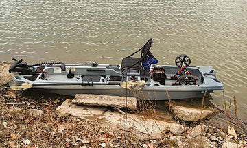 A rugged fishing boat with a trolling motor sits at the water's edge, ready for its LiTime trolling motor battery