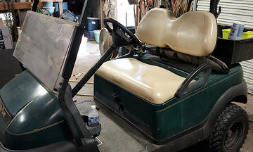 litime lithium golf cart battery customer review: A green golf cart sits in a garage, highlighting its interior design for a LiTime lithium battery upgrade