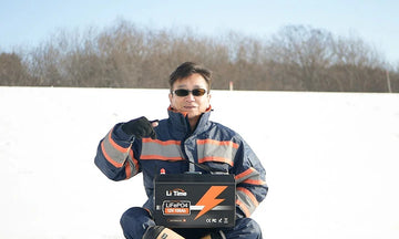 litime cold weather battery customer feedback with a man holding 12v 100ah lifepo4 battery in snow