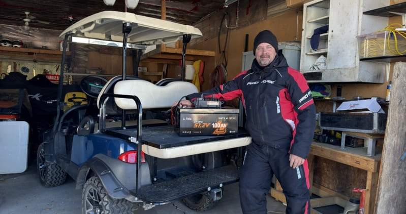 a man using a LiTime 51.2V 100Ah smart golf cart battery for his golf cart